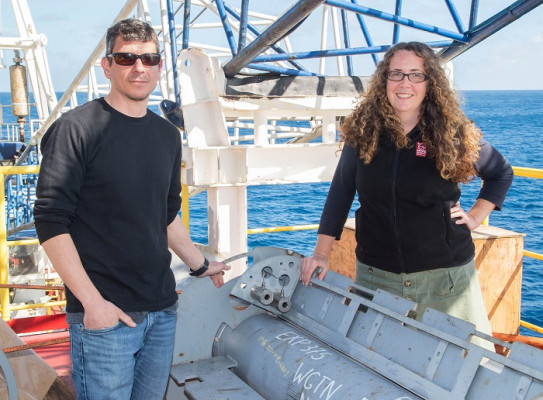 Dr Demian Saffer and Dr Laura Wallace with one of the observatory wellheads before it was installed