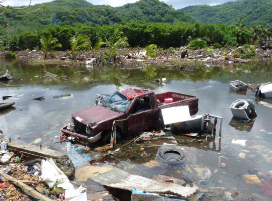 Vehicle and household items floating in sea water after Samoan Tsunami 2009